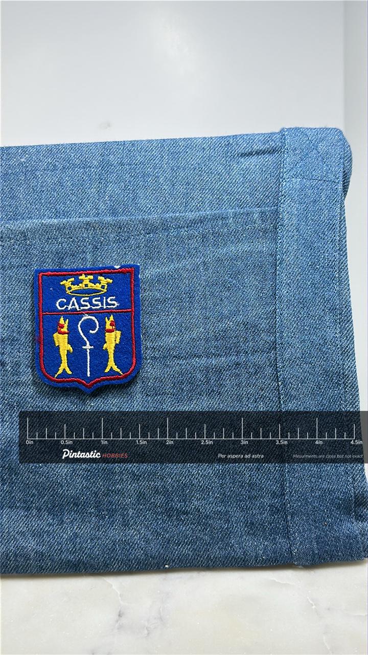 Cassis France Collectable Patch: Blue Shield Crest - Travel Souvenir with ruler overlay for size reference