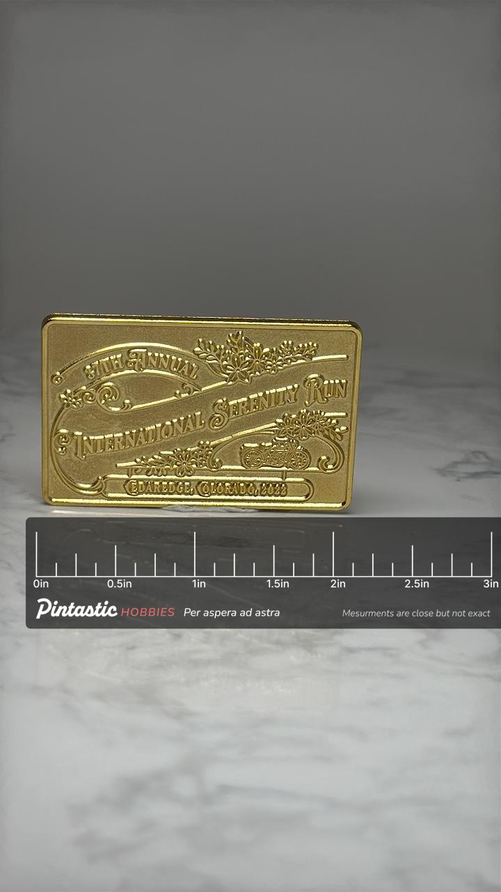 Vintage International Serenity Run Pin: Gold Tone - 2002 Event with ruler overlay for size reference