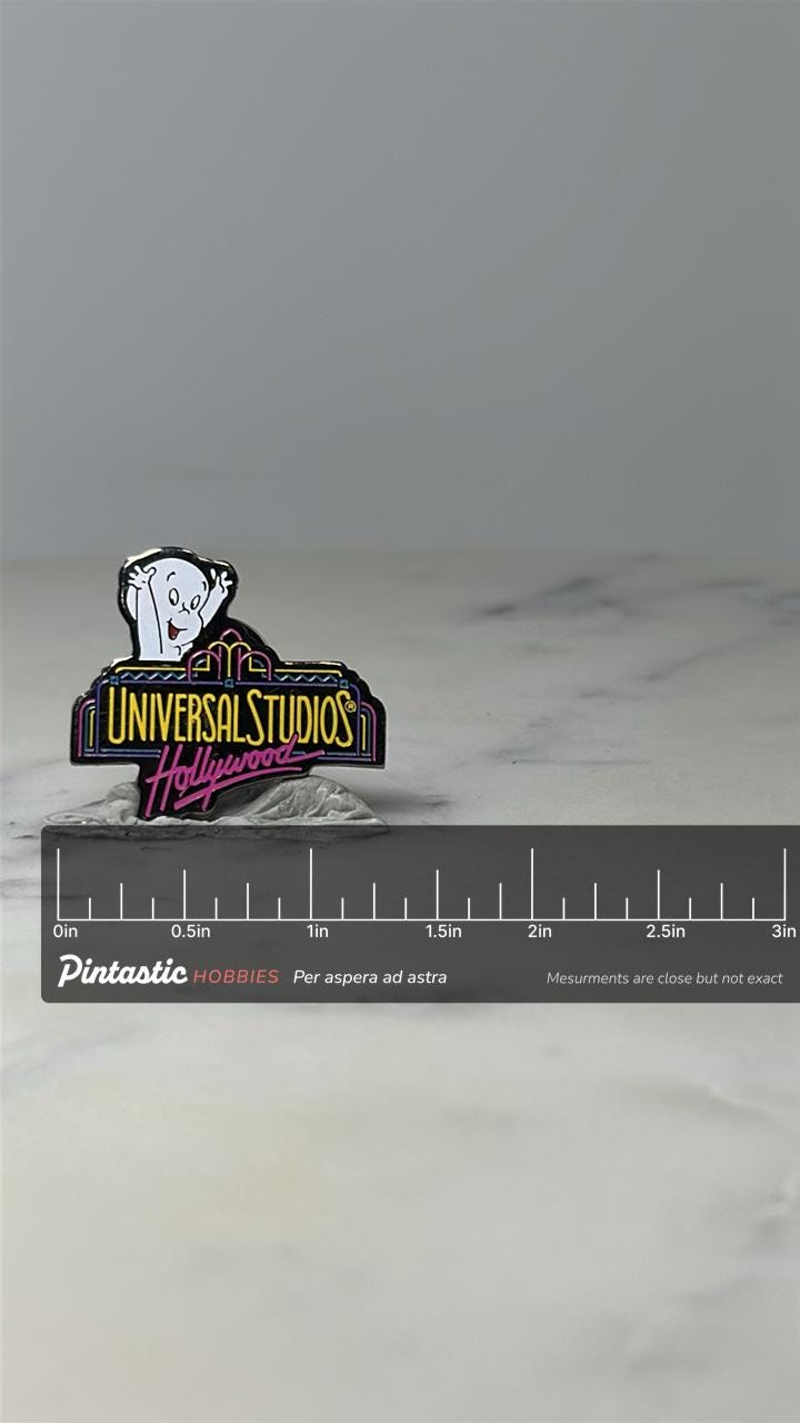 Vintage Casper Universal Studios Pin: Neon Enamel - 1990s Theme Park with ruler overlay for size reference