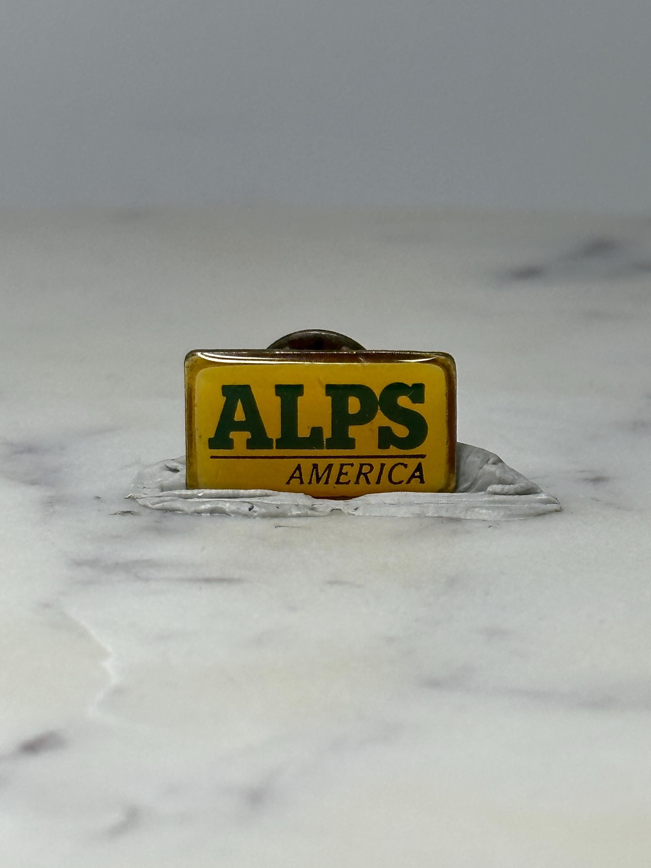 Vintage ALPS America Advertising Pin: Yellow Enamel - Retro Brand Accessory
