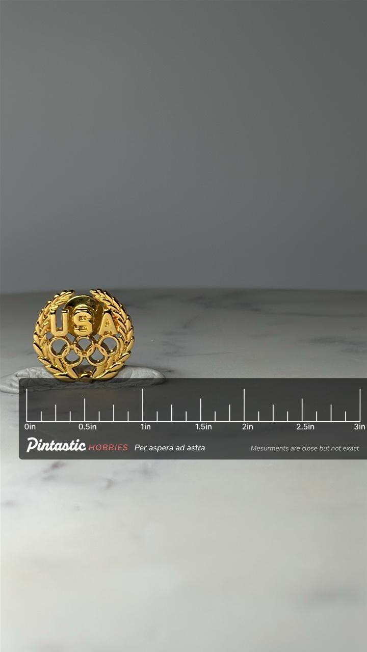 Vintage USA Olympic Rings Lapel Pin: Gold Tone - Patriotic Sports Accessory with ruler overlay for size reference