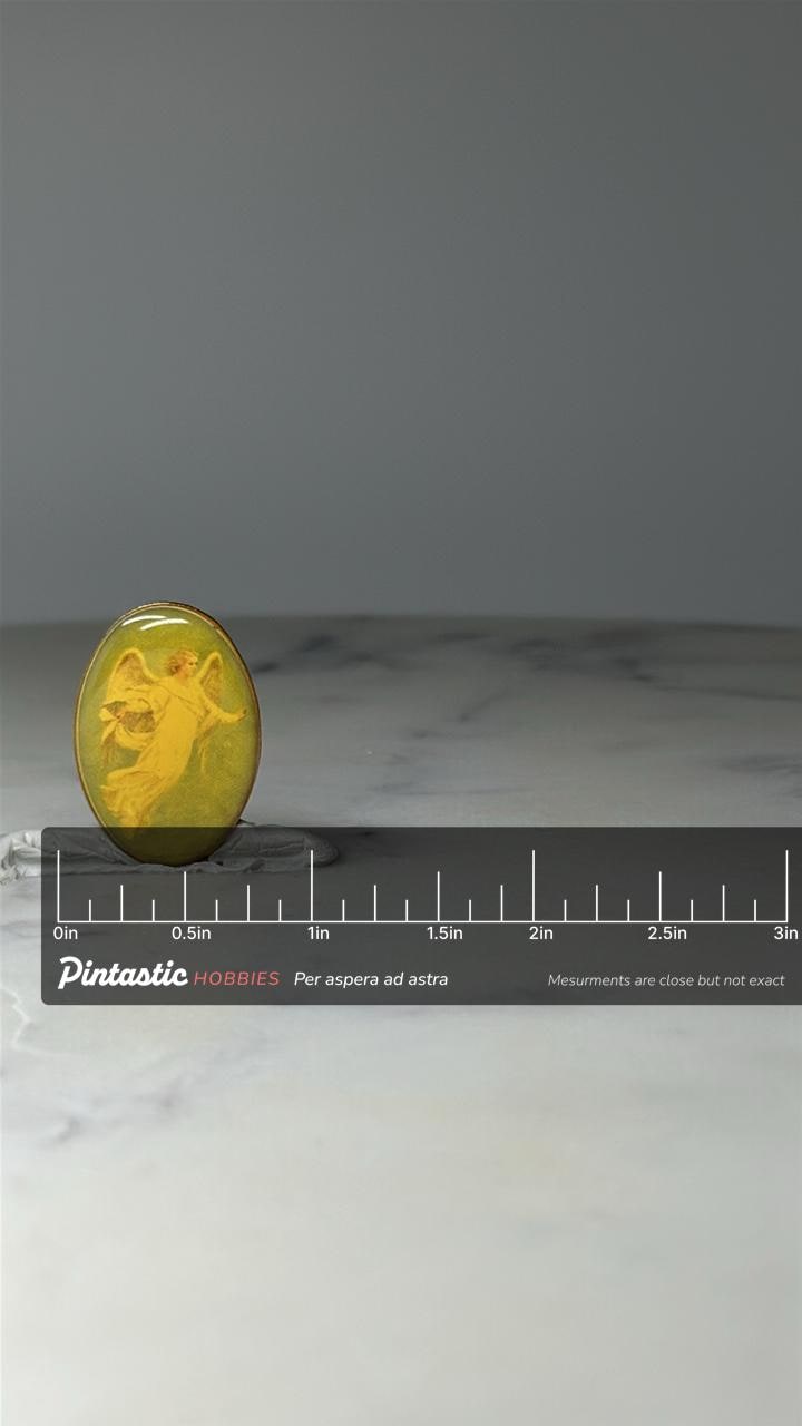 Vintage Angel Cameo Pin: Yellow on Green - Religious Accessory with ruler overlay for size reference
