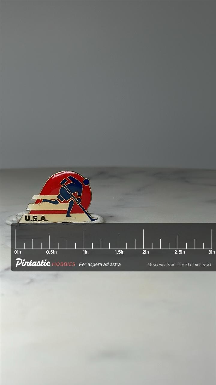 Vintage USA Hockey Enamel Pin: Red Blue - 1980s Sports Accessory with ruler overlay for size reference