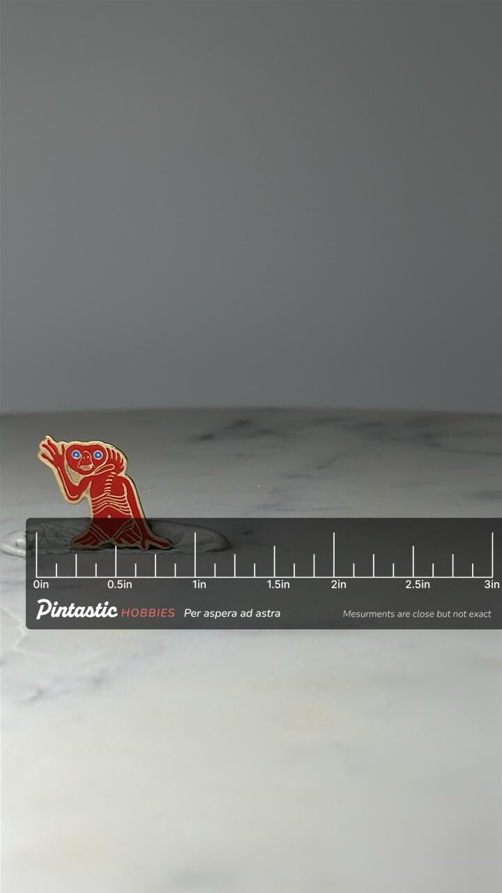 Vintage E.T. Extra Terrestrial Enamel Pin: Red Colored - Retro Movie Collectible with ruler overlay for size reference