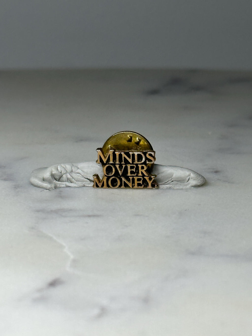 Vintage Minds Over Money Lapel Pin: Gold Tone - Motivational Accessory
