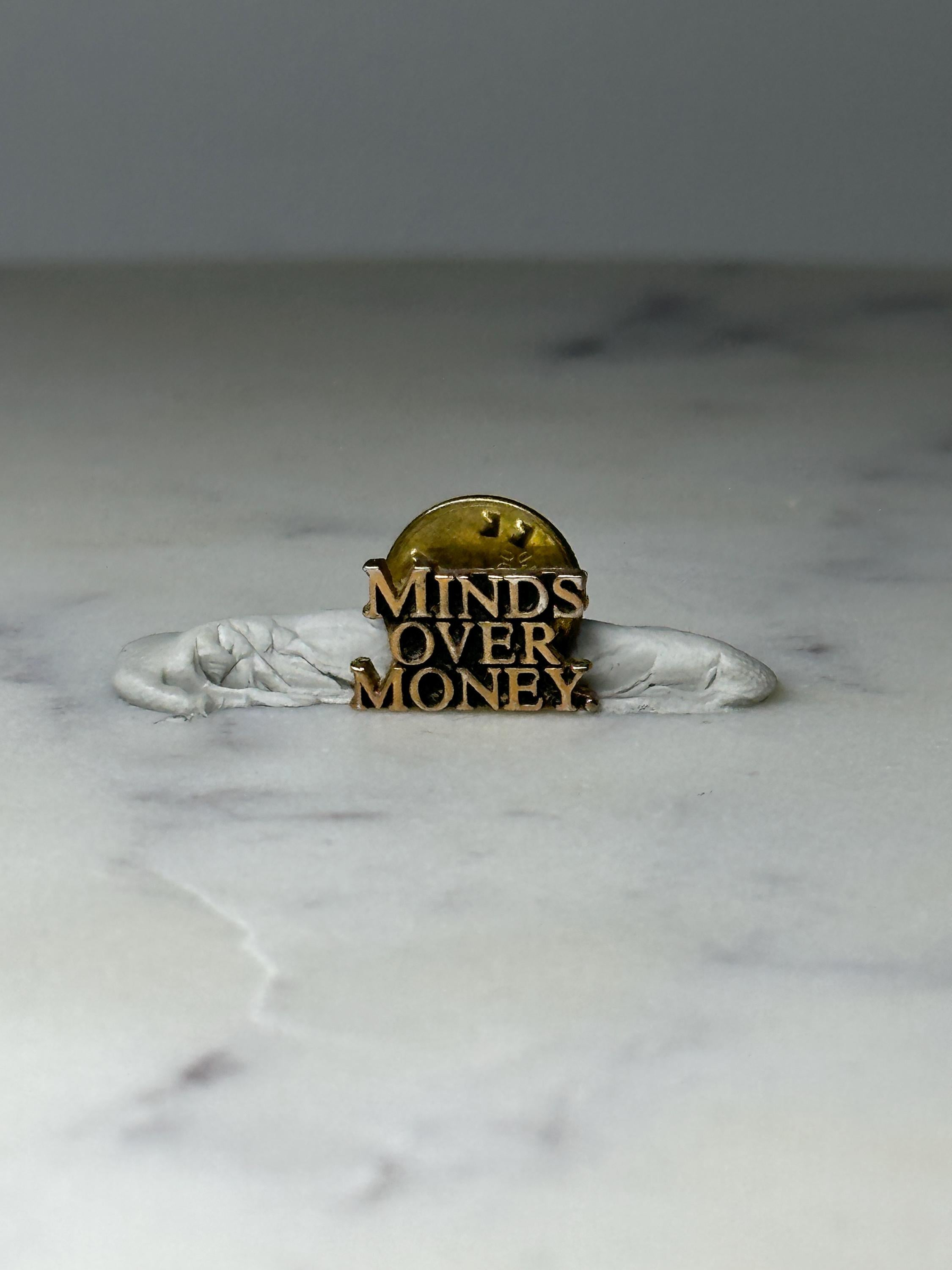 Vintage Minds Over Money Lapel Pin: Gold Tone - Motivational Accessory