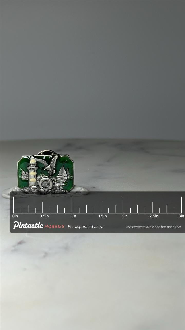 Vintage Lighthouse Scenic Souvenir Pin: Silver Tone & Green - Coastal Accessory with ruler overlay for size reference