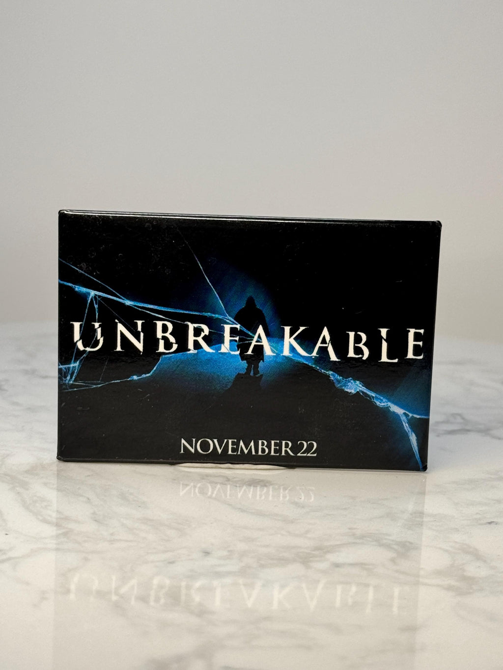Vintage Unbreakable Movie Promo Pin: Black Enamel - 2000s Film Accessory