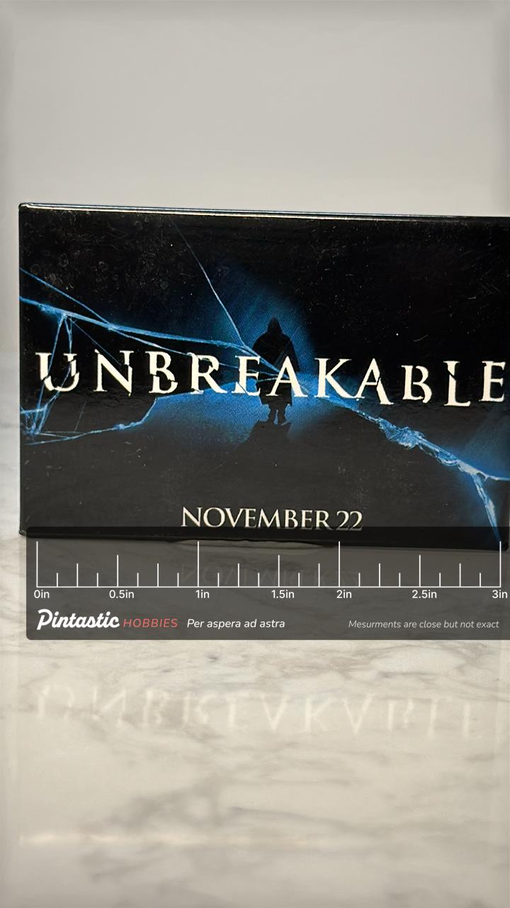 Vintage Unbreakable Movie Promo Pin: Black Enamel - 2000s Film Accessory with ruler overlay for size reference