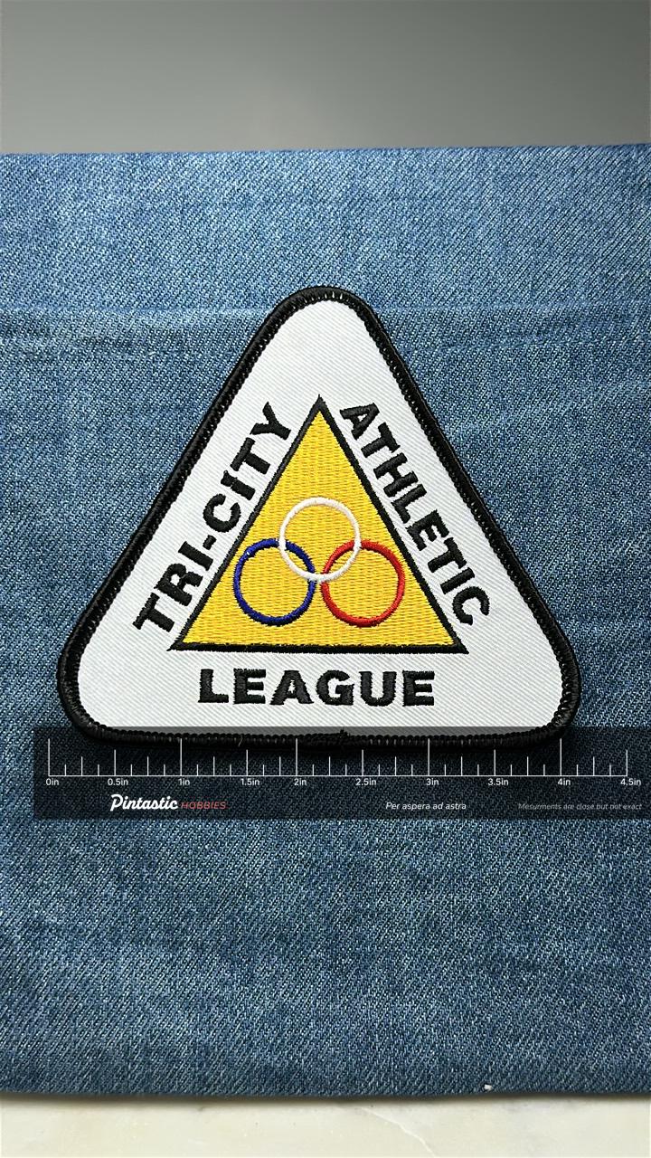 Tri-City Athletic League Patch: Triangle Yellow - Sports Accessory with ruler overlay for size reference