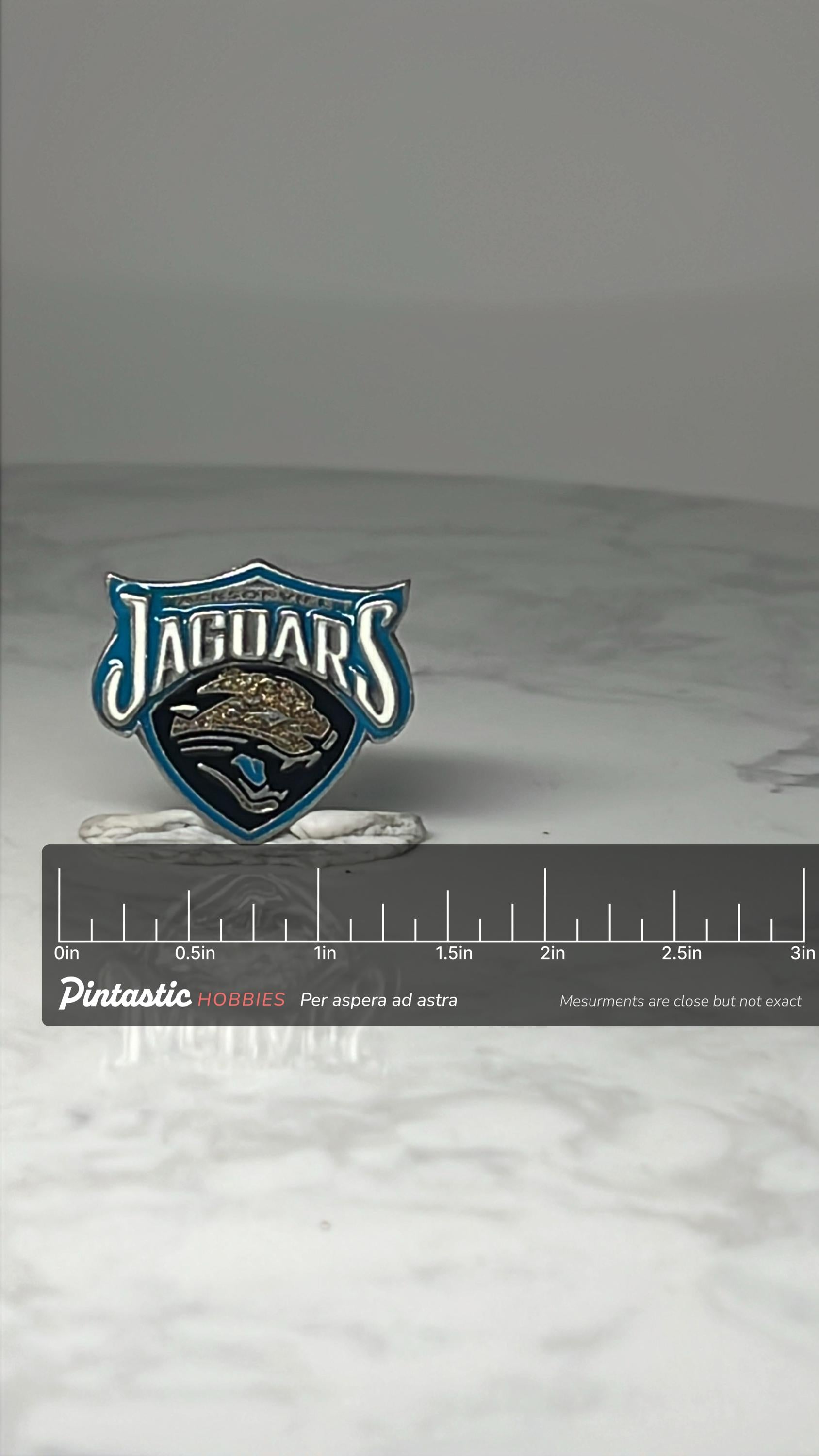 Vintage Jacksonville Jaguars Enamel Pin: Teal & Black - NFL Football Accessory with ruler overlay for size reference