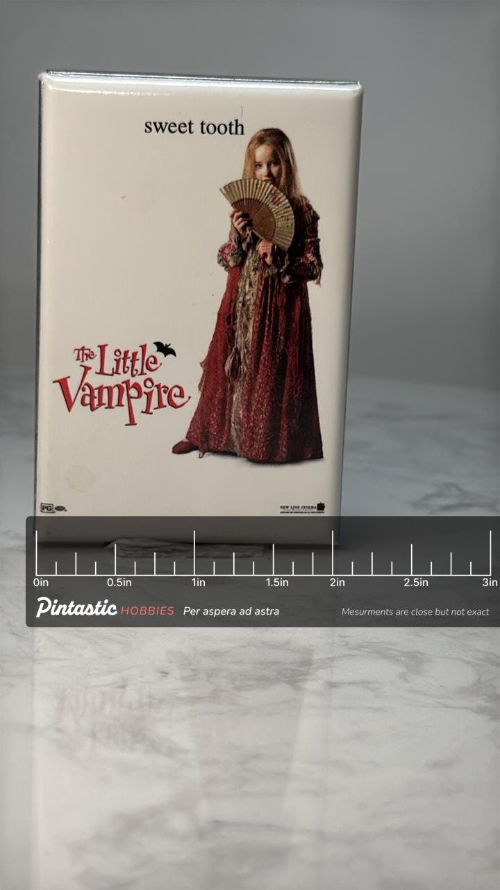 Vintage The Little Vampire Pin: Glossy White Photo - 2000s Movie Promo Accessory with ruler overlay for size reference