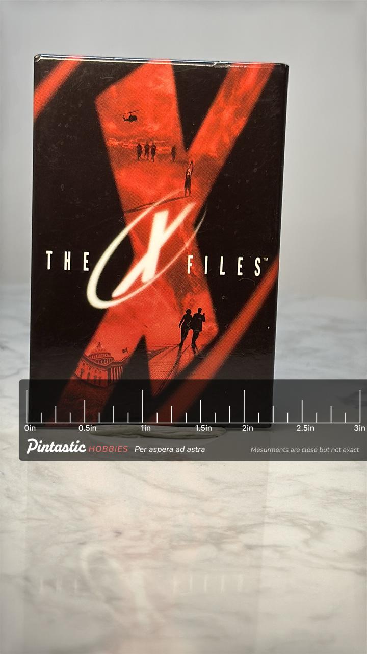 Vintage The X Files Logo Pin: Red Black Glossy - 1990s TV Accessory with ruler overlay for size reference