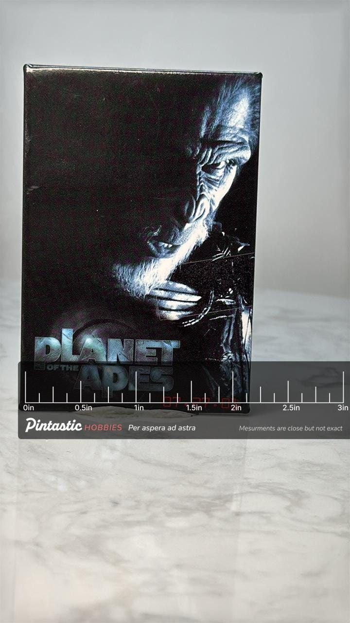 Vintage Planet of the Apes Movie Pin: Glossy Black - 2001 Film Accessory with ruler overlay for size reference