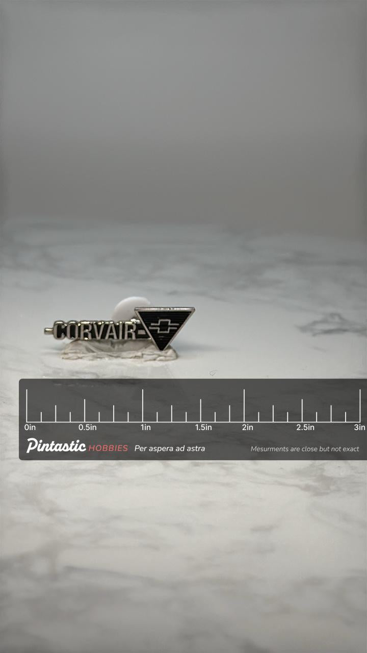 Vintage Chevrolet Corvair Emblem Pin: Silver Tone - 1960s Auto Accessory with ruler overlay for size reference