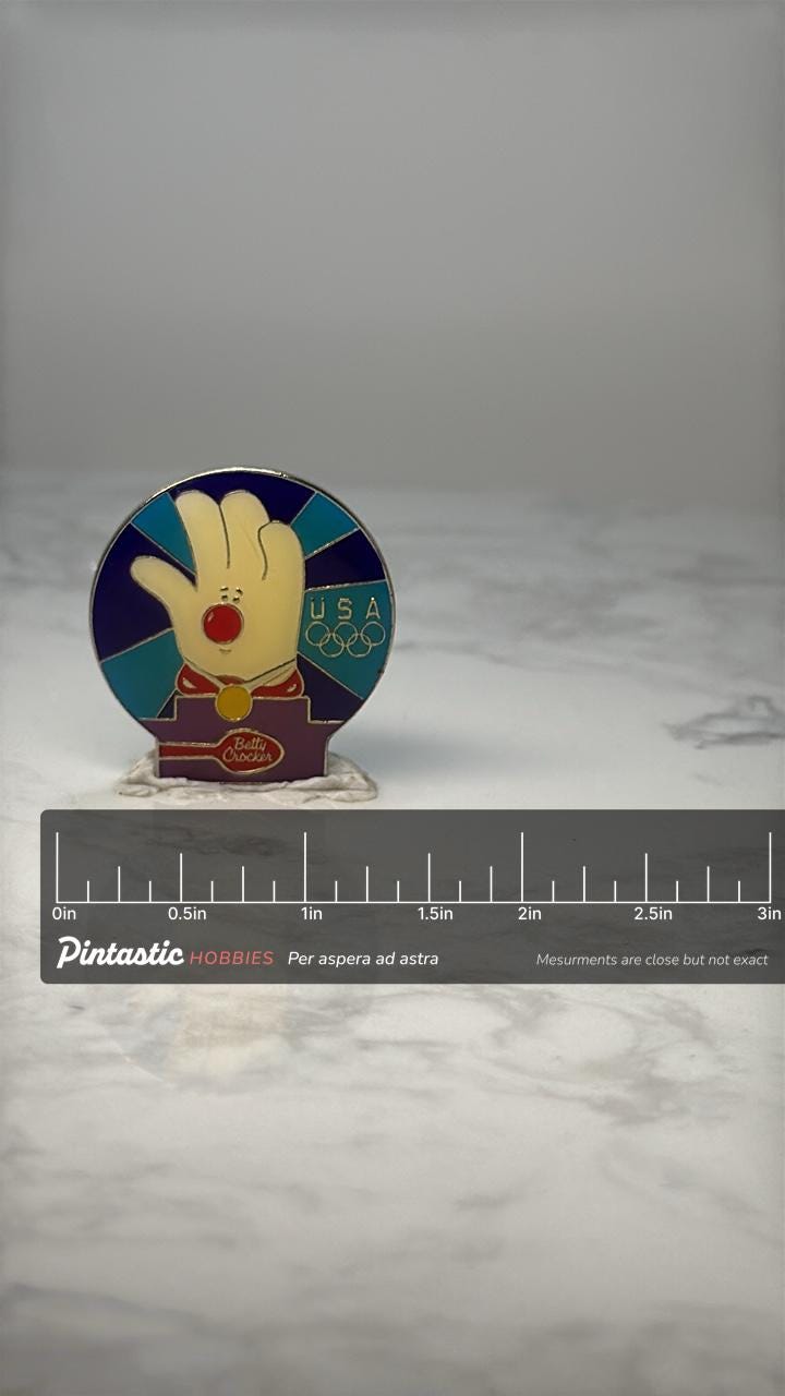 Vintage Betty Crocker USA Olympics Enamel Pin: Colorful - 1996 Sponsor Accessory with ruler overlay for size reference