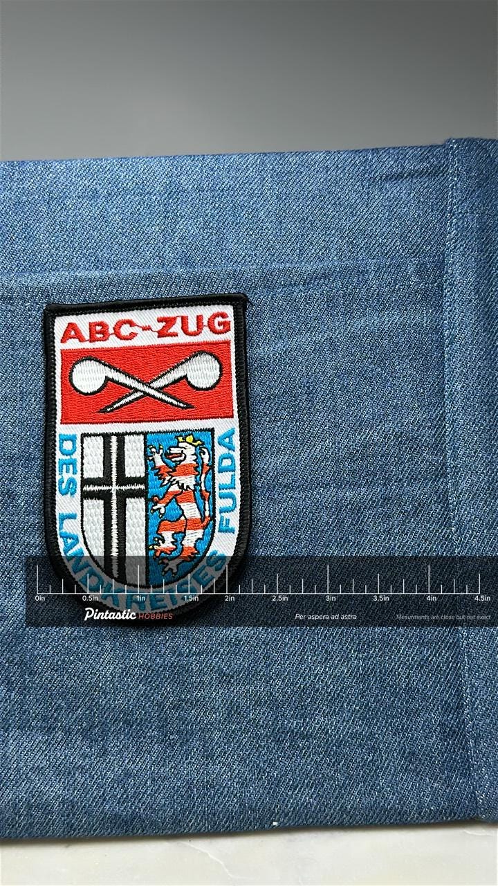 ABC-ZUG Fulda Patch: Red Shield Crest - German Civil Defense Accessory with ruler overlay for size reference
