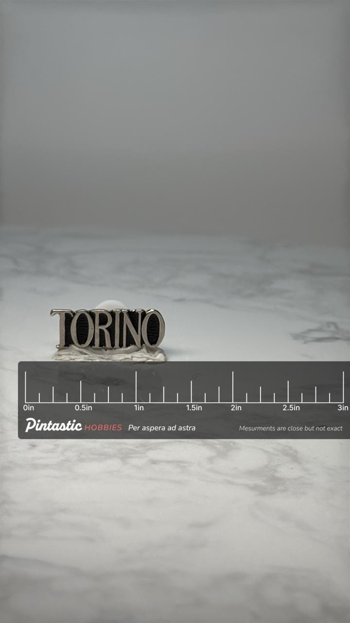 Vintage Ford Torino Emblem Pin: Silver Tone - Classic Car Accessory with ruler overlay for size reference