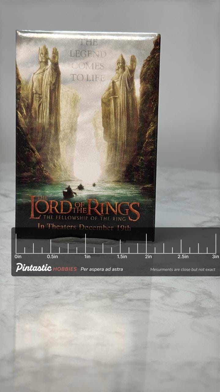 Vintage Lord of the Rings Pin: Glossy Poster Art - 2001 Film Promo Accessory with ruler overlay for size reference