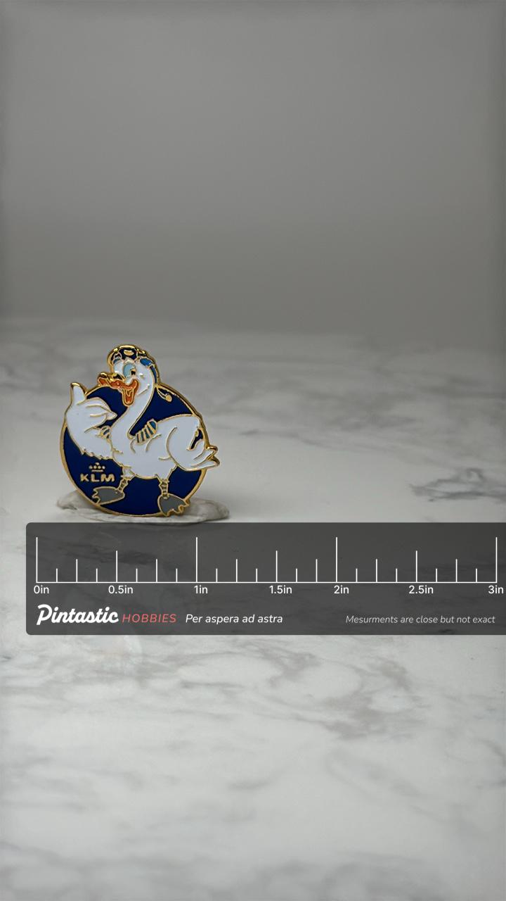 Vintage KLM Airline Enamel Pin: Blue & Gold Tone - Aviation Accessory with ruler overlay for size reference