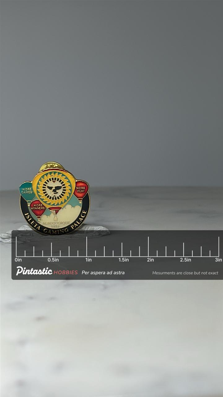 Vintage Isleta Gaming Palace Pin: Gold Tone Enamel - Albuquerque Casino Souvenir with ruler overlay for size reference