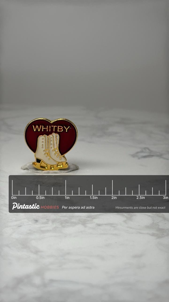Vintage Whitby Ice Skates Enamel Pin: Red & Gold - Travel Souvenir Accessory with ruler overlay for size reference