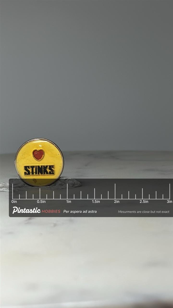 Vintage Love Stinks Enamel Pin: Yellow Heart Design - Novelty Accessory with ruler overlay for size reference