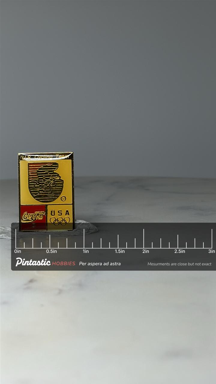 Vintage U.S. Cycling Team Enamel Pin: Red Yellow Black - Olympic Era Accessory with ruler overlay for size reference