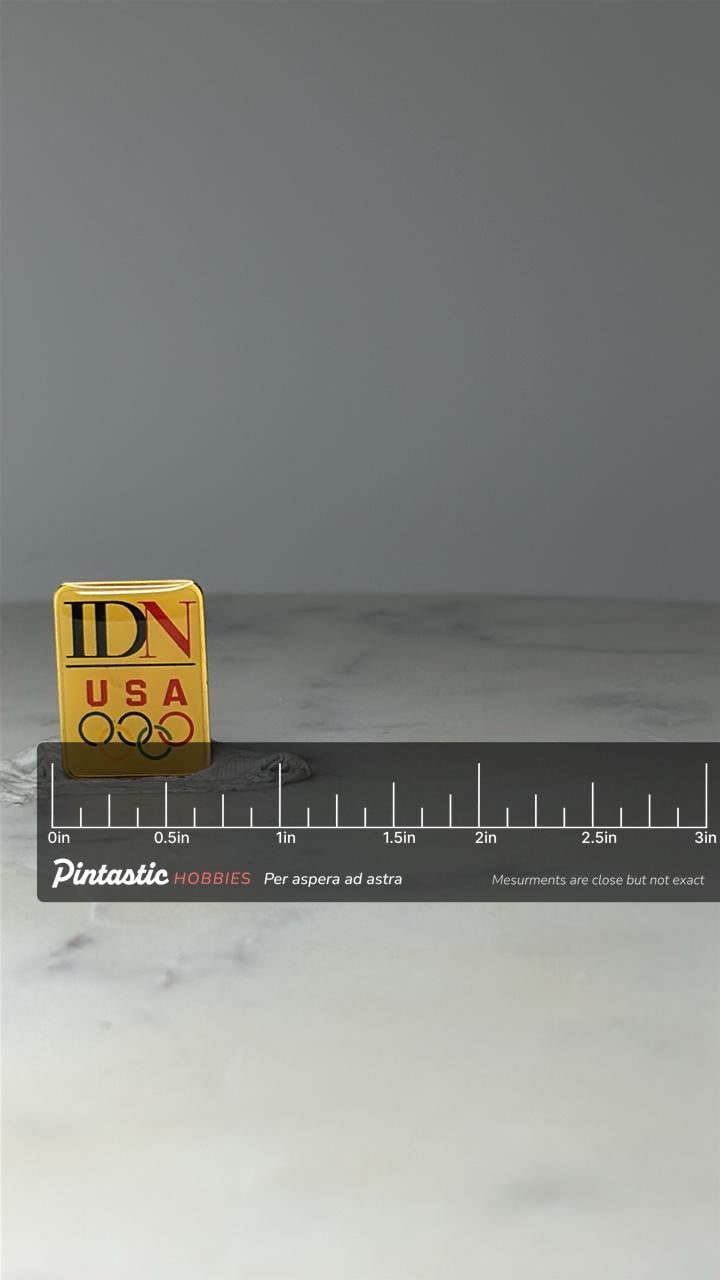 Vintage IDN USA Olympic Pin: Gold Tone Enamel - 1990s Games Accessory with ruler overlay for size reference