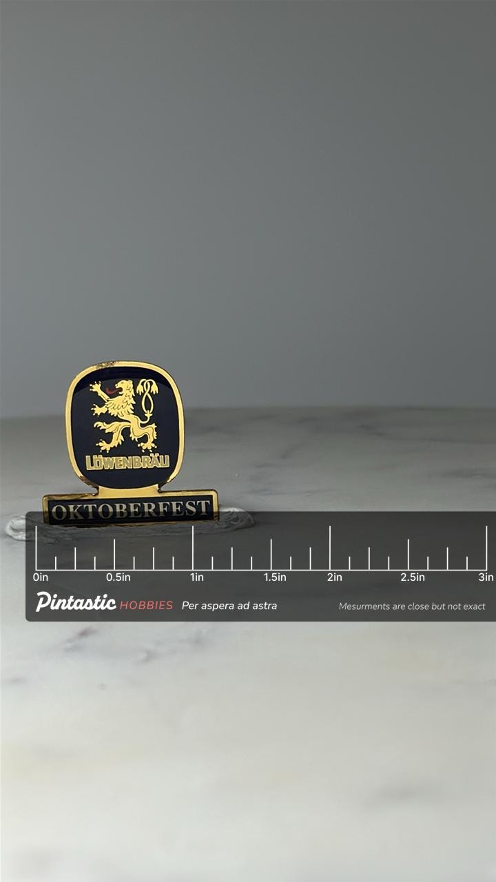 Vintage Lowenbrau Oktoberfest Enamel Pin: Blue & Gold - Beer Fest Accessory with ruler overlay for size reference