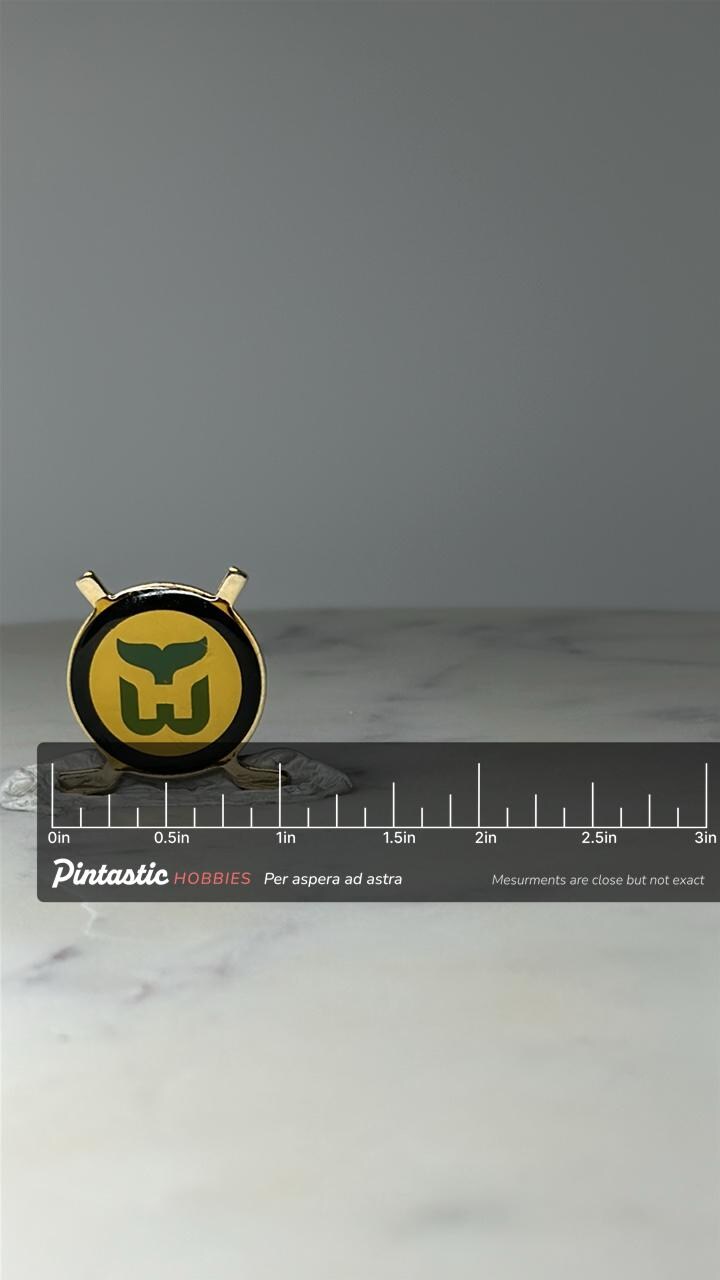 Vintage Hartford Whalers Enamel Pin: Green & Gold - NHL Hockey with ruler overlay for size reference