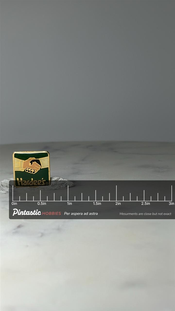 Vintage Hardees Handshake Logo Enamel Pin: Green Gold - 1990s Accessory with ruler overlay for size reference
