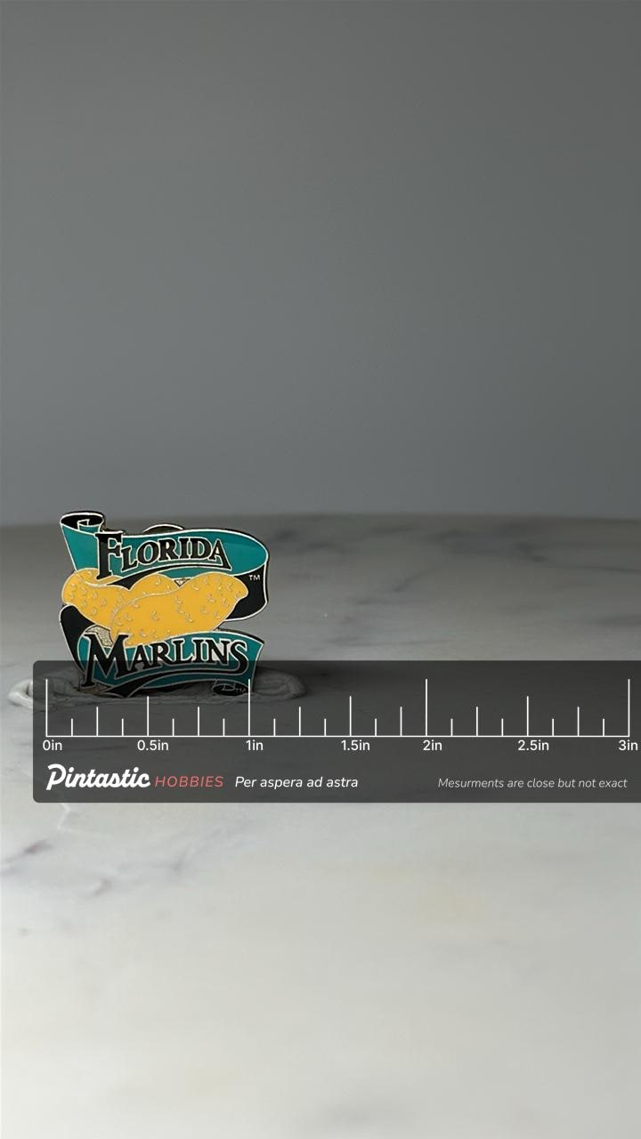 Vintage Florida Marlins Enamel Pin: Teal & Black - 1990s MLB Accessory with ruler overlay for size reference