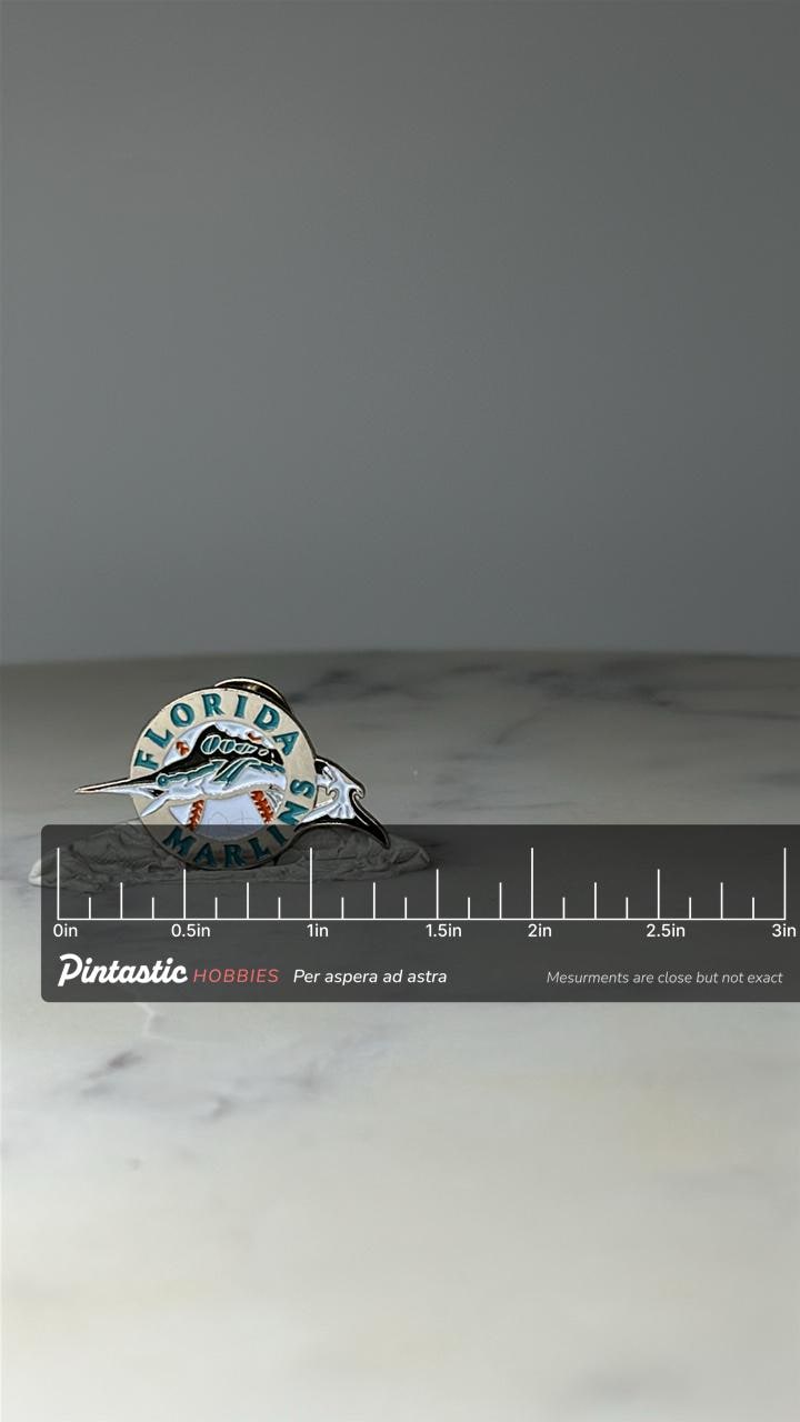 Vintage Florida Marlins Enamel Pin: Teal & Silver - MLB Baseball Accessory with ruler overlay for size reference