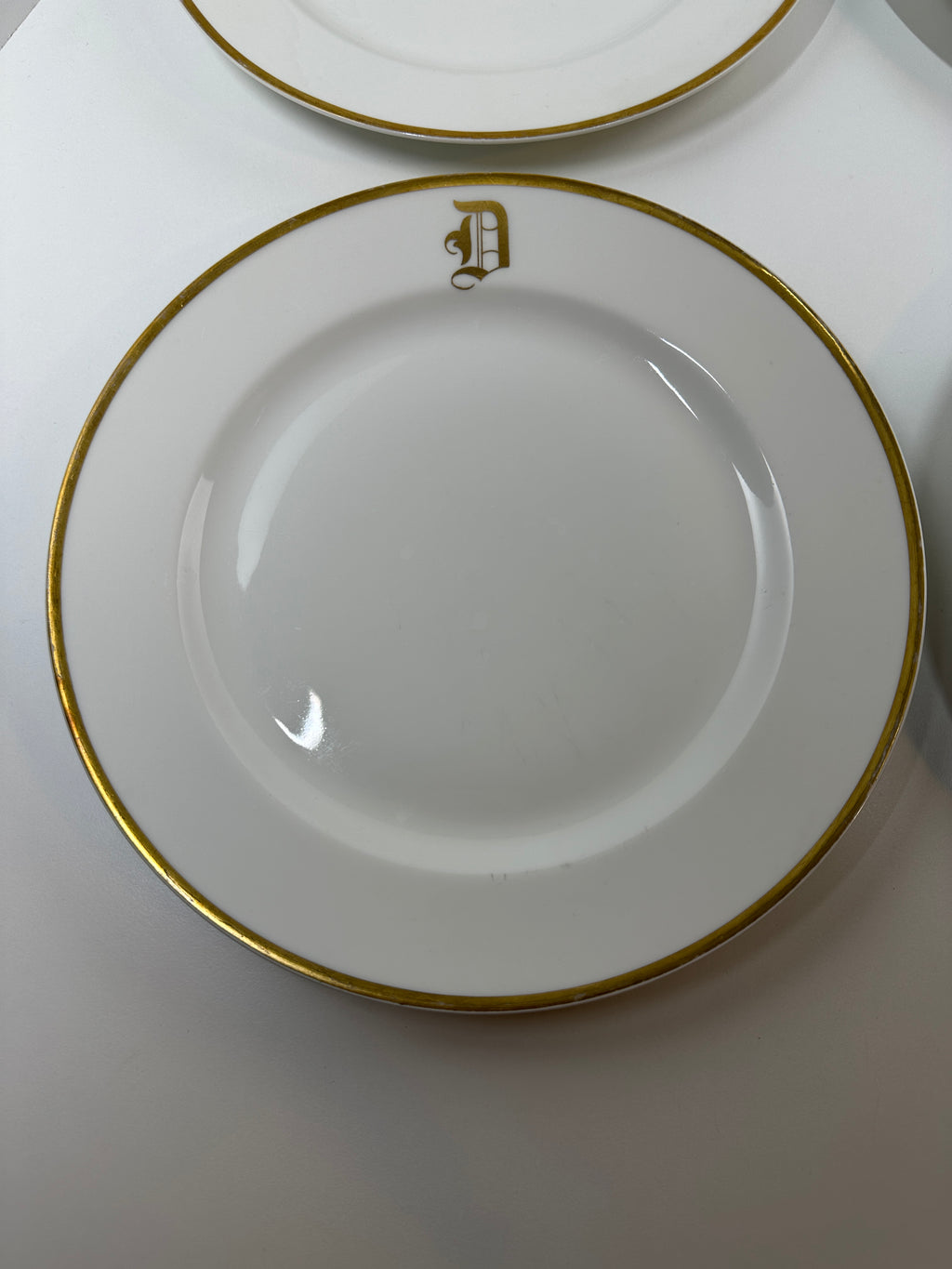 Set of four Haviland France white dinner plates with gold trim and monogram letter D