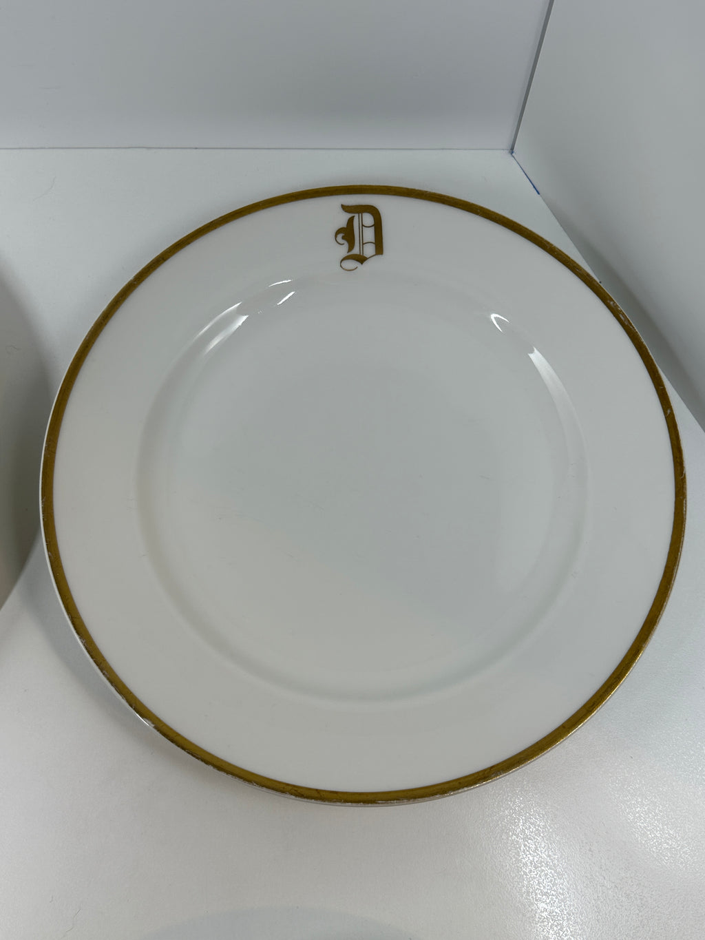 Set of four Haviland France white dinner plates with gold trim and monogram letter D