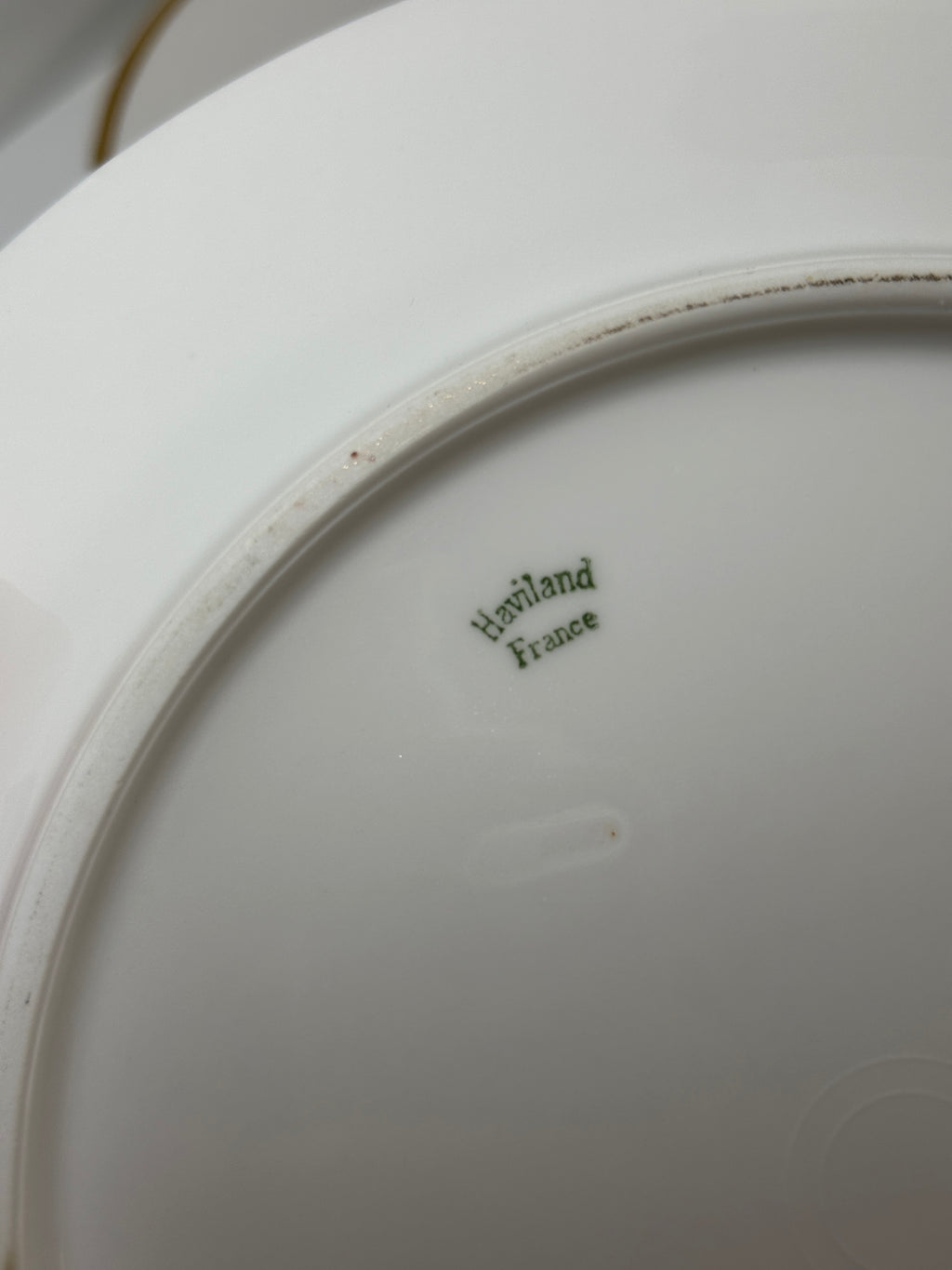 Set of four Haviland France white dinner plates with gold trim and monogram letter D