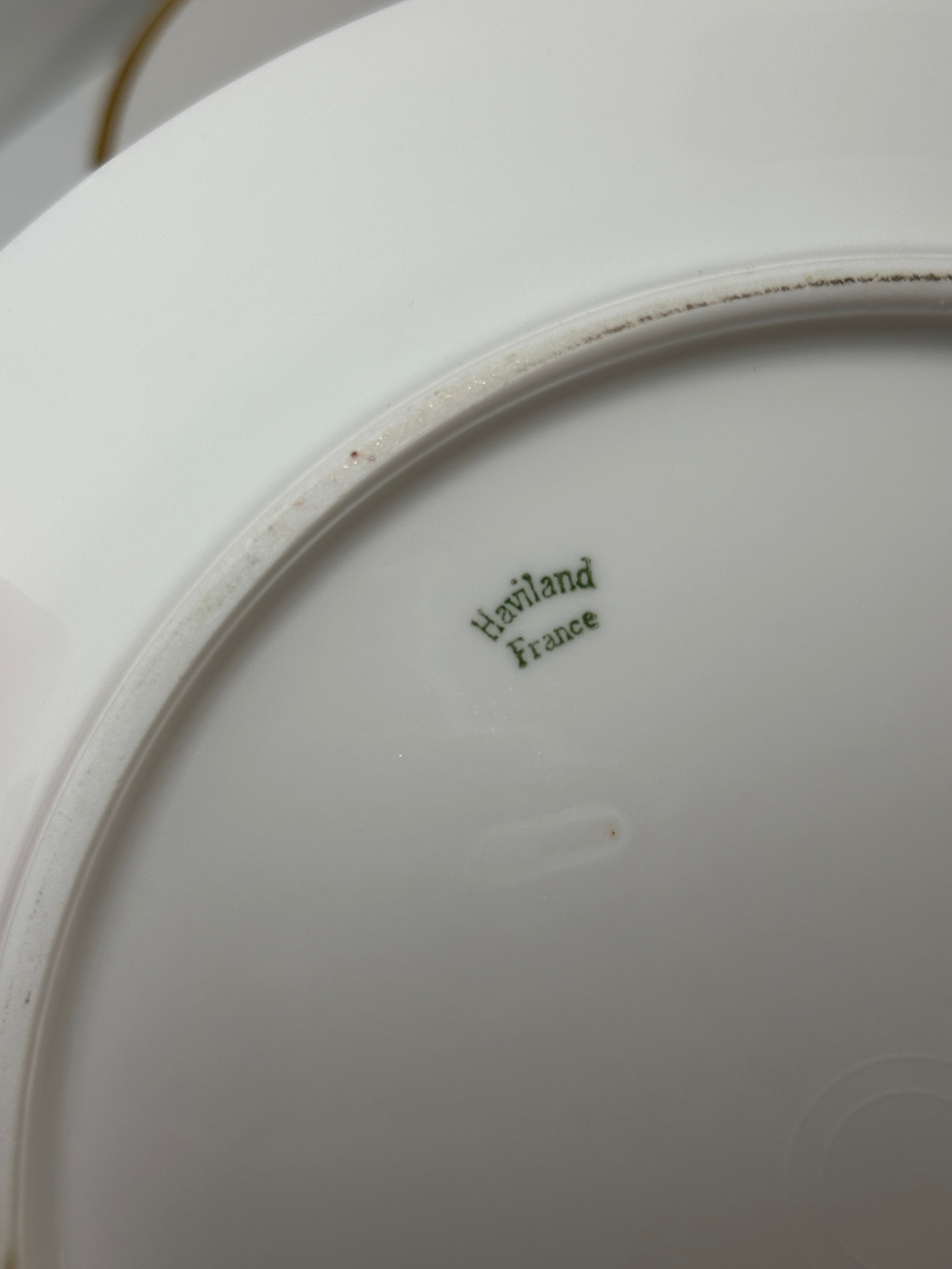 Set of four Haviland France white dinner plates with gold trim and monogram letter D