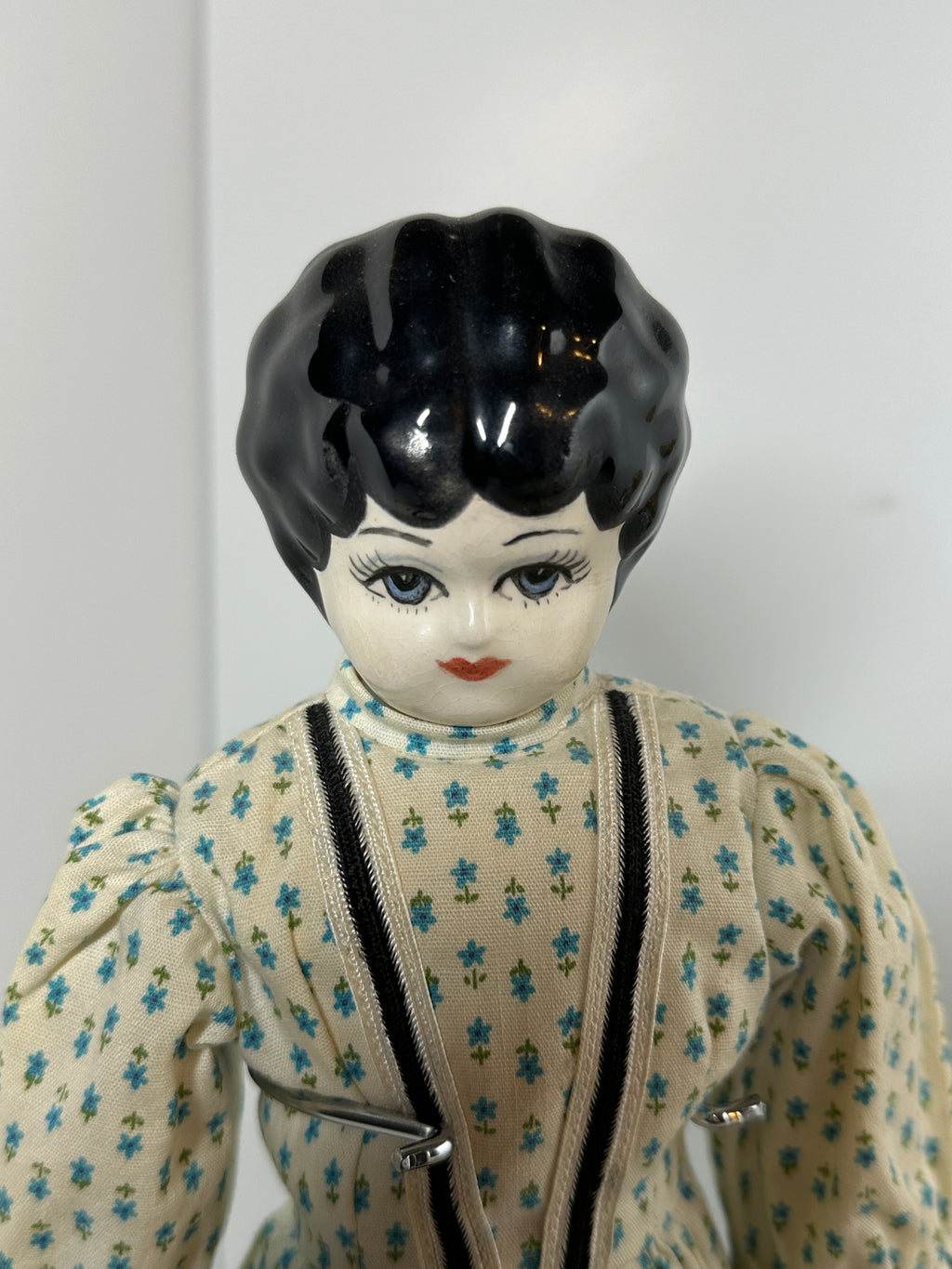 Vintage porcelain china head doll set with two dolls in period clothing, one standing and one seated with lace dress