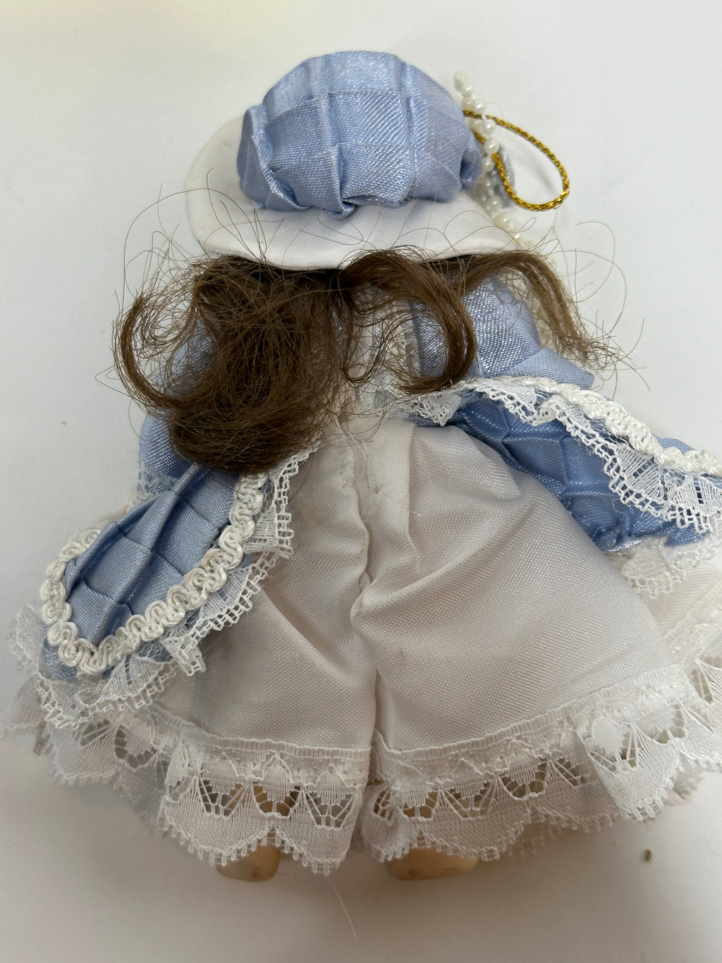 Set of two miniature porcelain dolls wearing blue vintage style lace dresses with painted faces