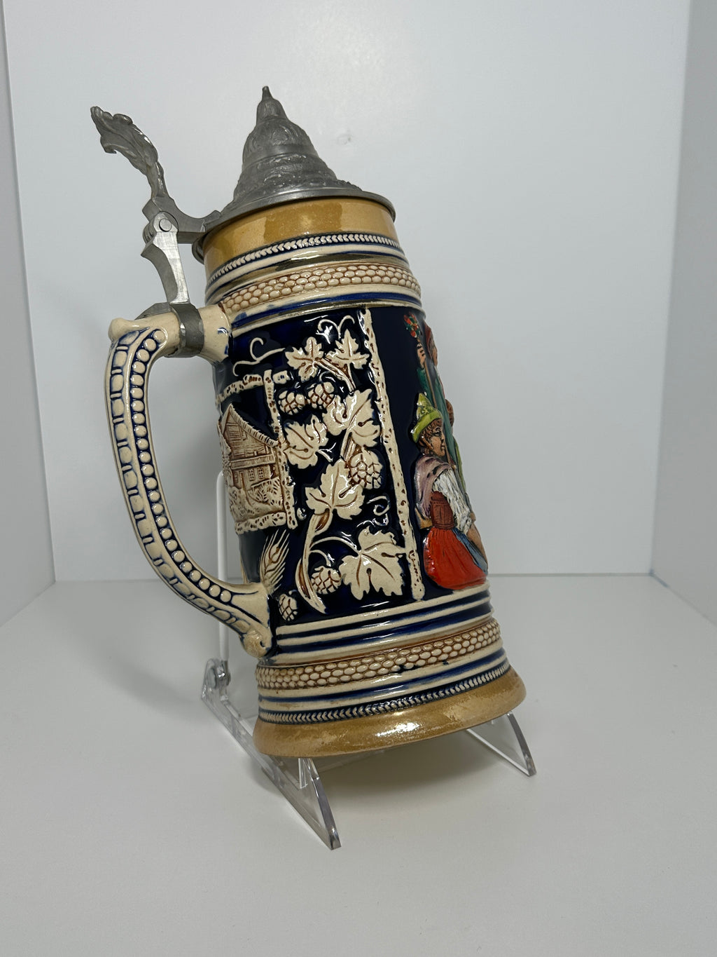 German decorative beer stein with pewter lid, blue and tan raised relief village design, marked 160