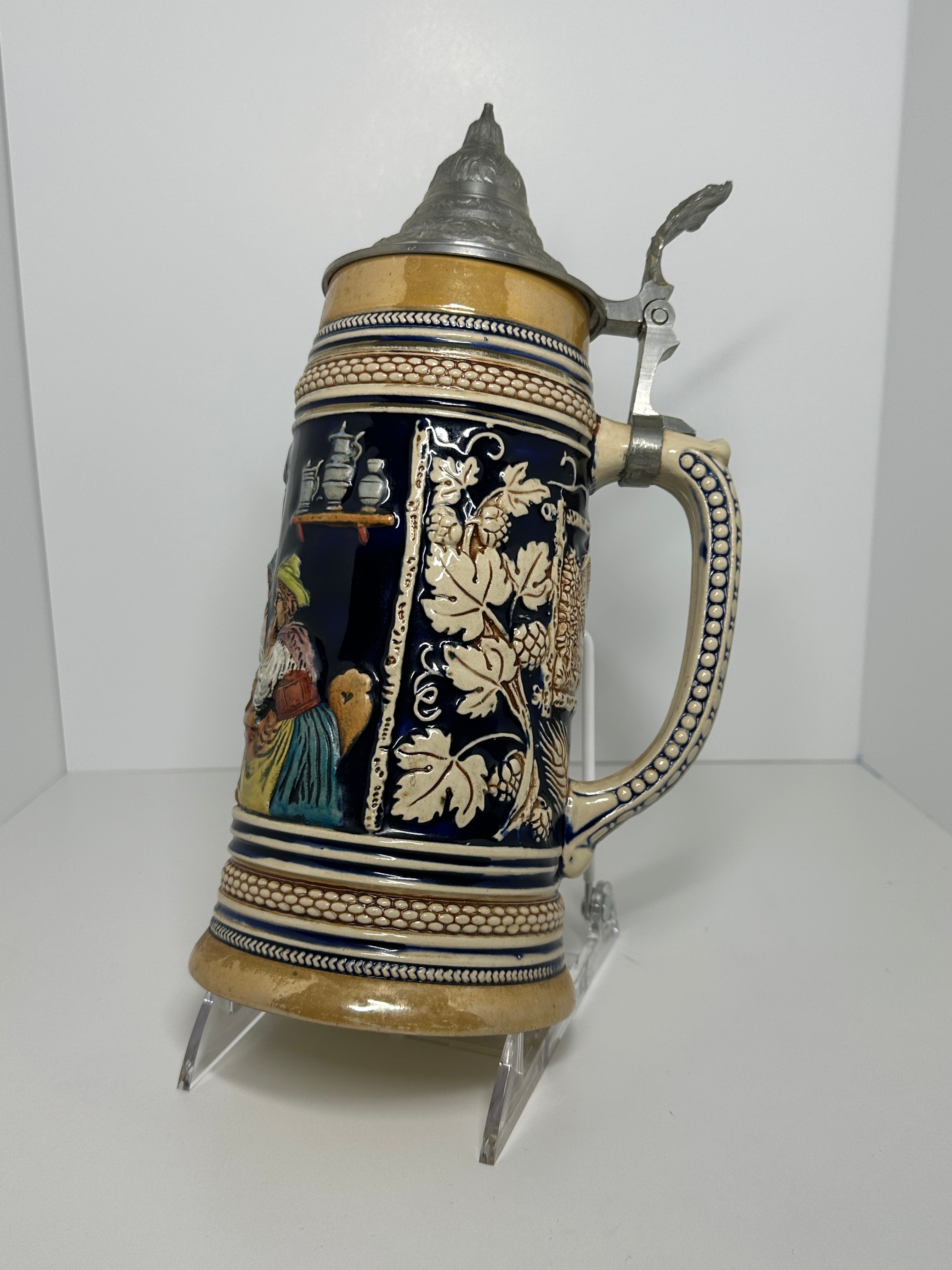 German decorative beer stein with pewter lid, blue and tan raised relief village design, marked 160