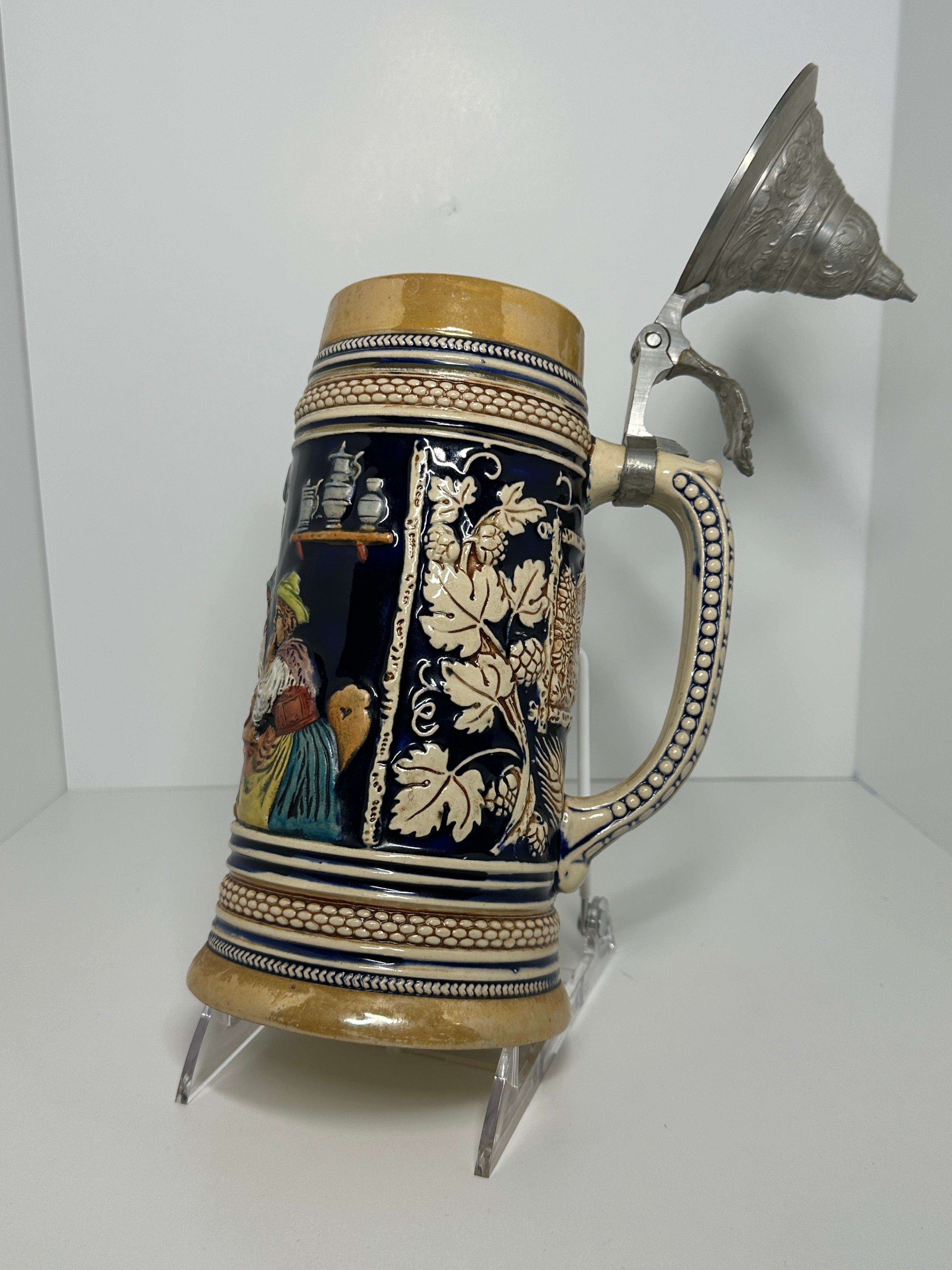 German decorative beer stein with pewter lid, blue and tan raised relief village design, marked 160