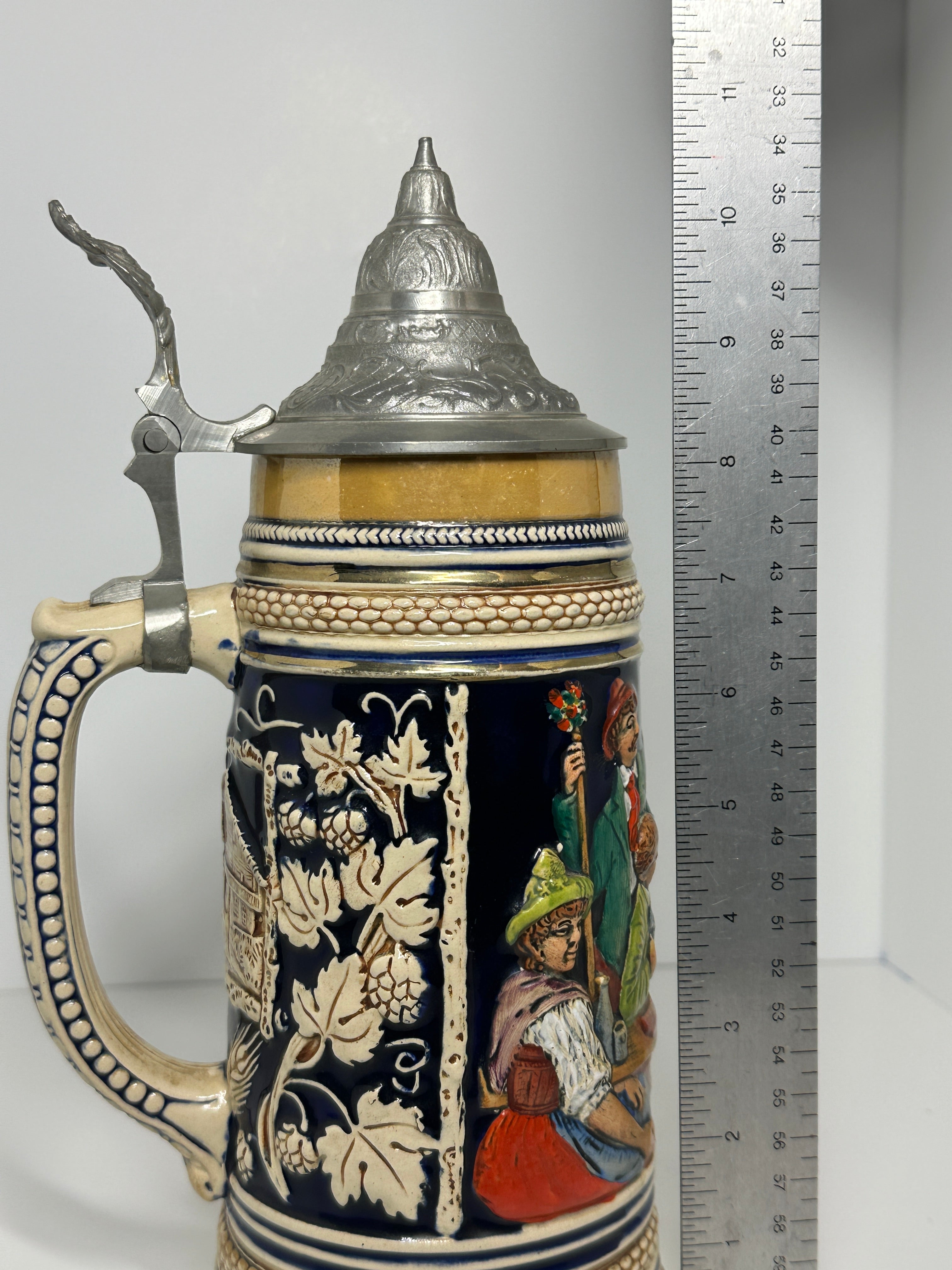 German decorative beer stein with pewter lid, blue and tan raised relief village design, marked 160