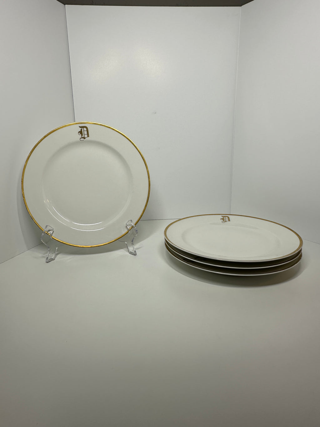 Set of four Haviland France white dinner plates with gold trim and monogram letter D
