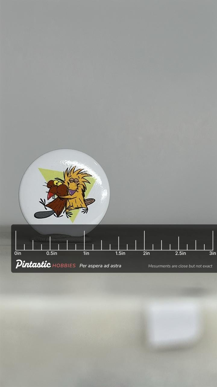 Vintage Angry Beavers Button Pin: Retro Cartoon White Finish - 90s Nostalgia Accessory with ruler overlay for size reference