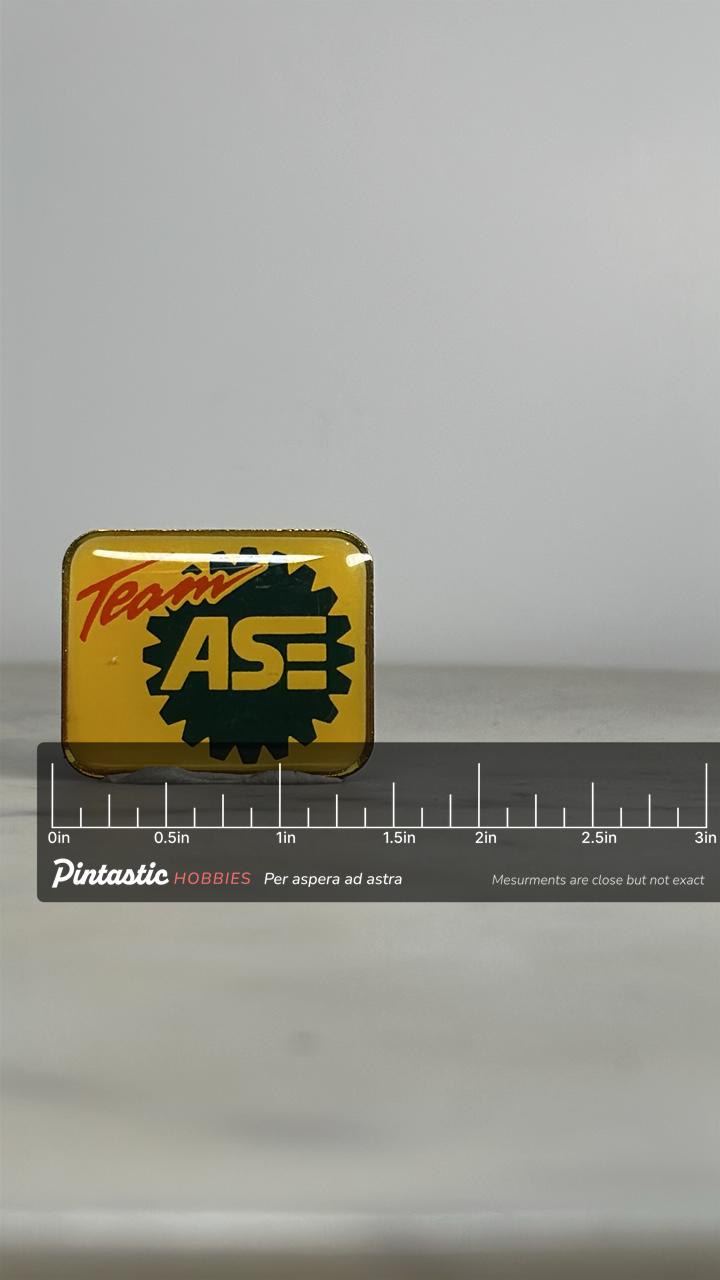 Team ASE Enamel Pin: Yellow Gear Logo - Retro Auto Accessory with ruler overlay for size reference