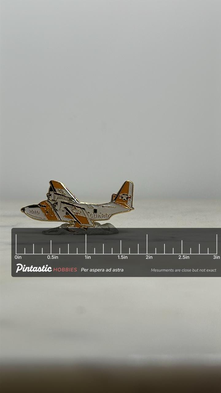 U.S. Coast Guard HC-130 Hercules Pin: Orange & White Aircraft – Military Collectible with ruler overlay for size reference
