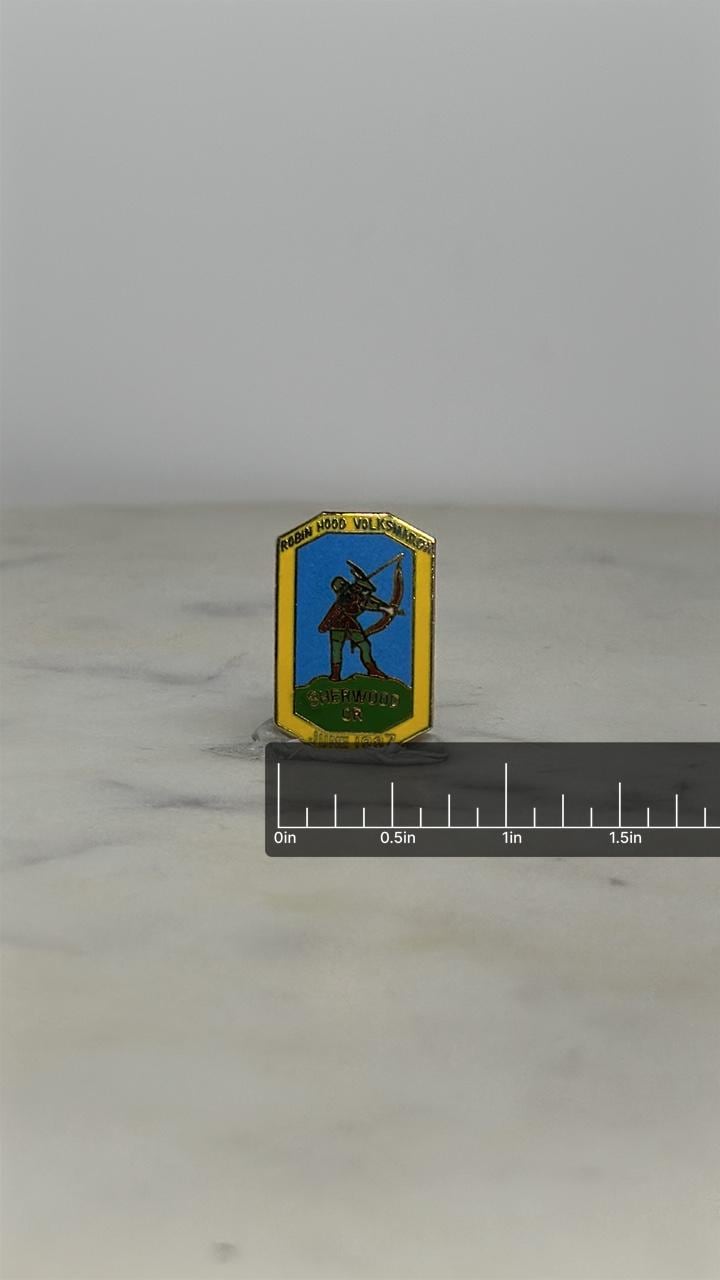 Robin Hood Volksmarch Pin: Enamel Shield Design - 1987 Souvenir Accessory with ruler overlay for size reference