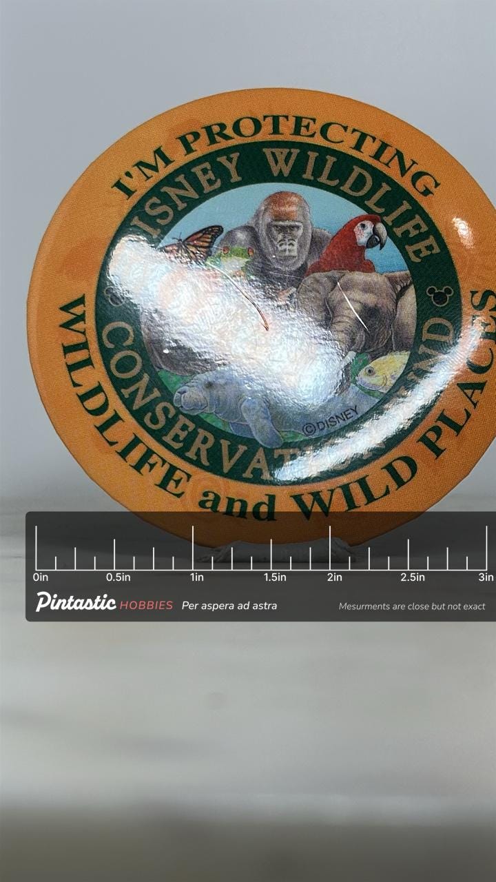 Disney Wildlife Conservation Pin: Multicolor Round - Animal Kingdom Accessory with ruler overlay for size reference